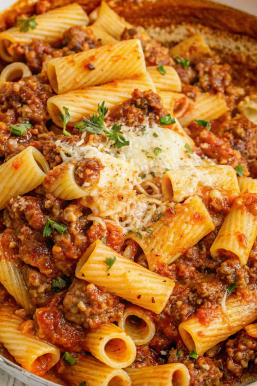 Beef pasta in tomato sauce with grated parmesan.