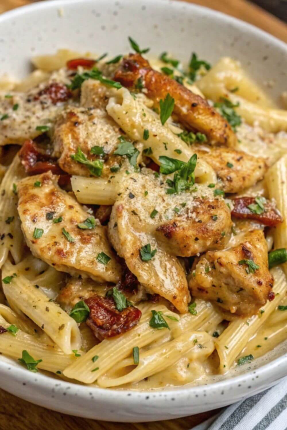 Chicken pasta with sun dried tomatoes and herbs in a cheese sauce.