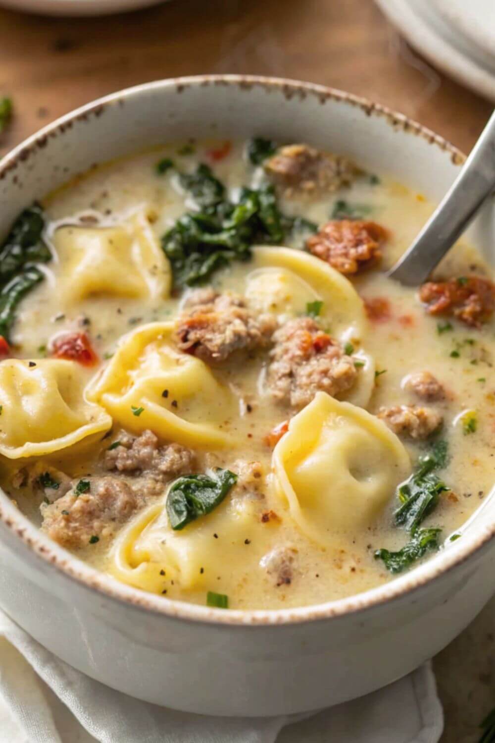 Sausage tortellini soup in a bowl.