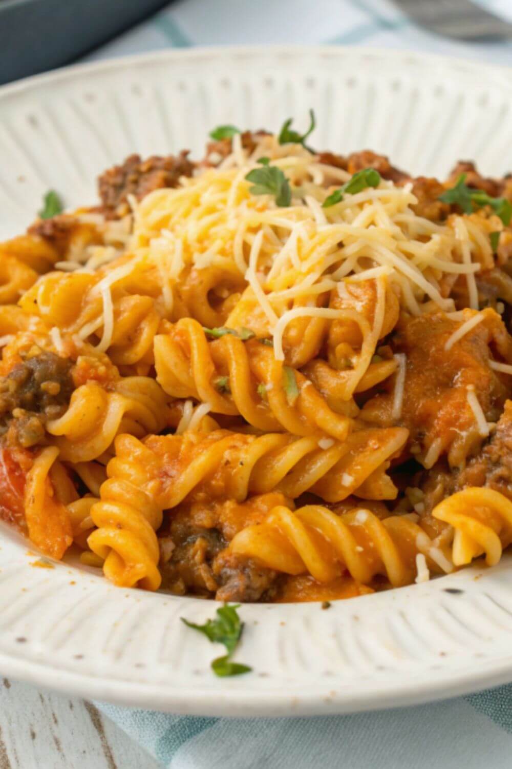 Taco pasta in an elegant dish with cheese topping.