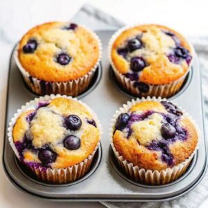 Blueberry and cottage cheese muffins in a muffin tin.