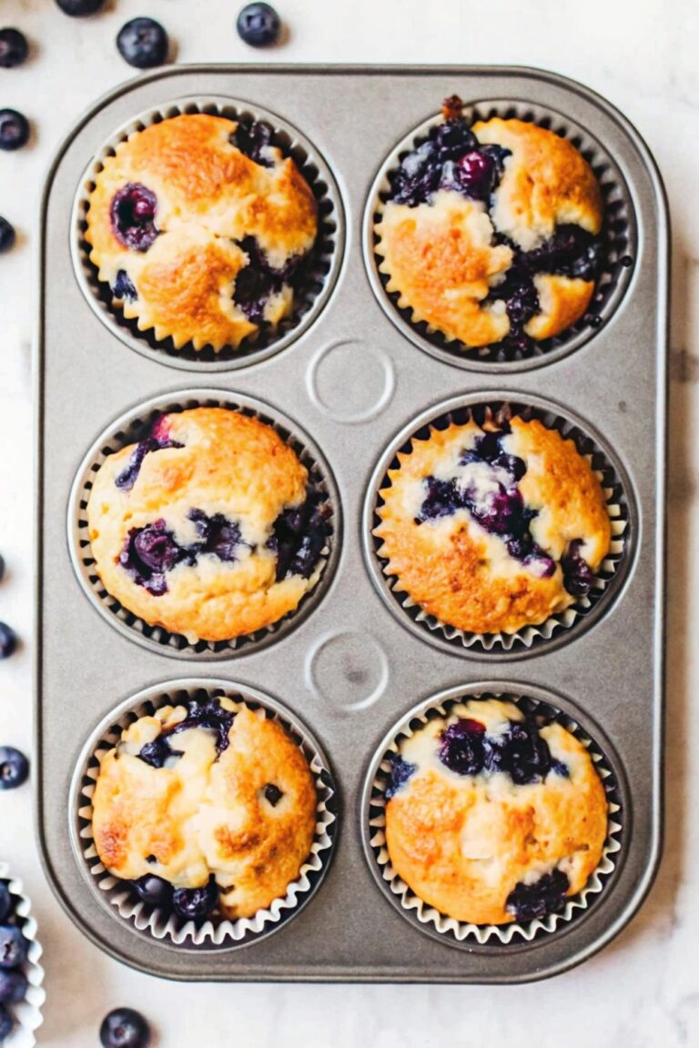 Blueberry and cottage cheese muffins in a muffin tin.