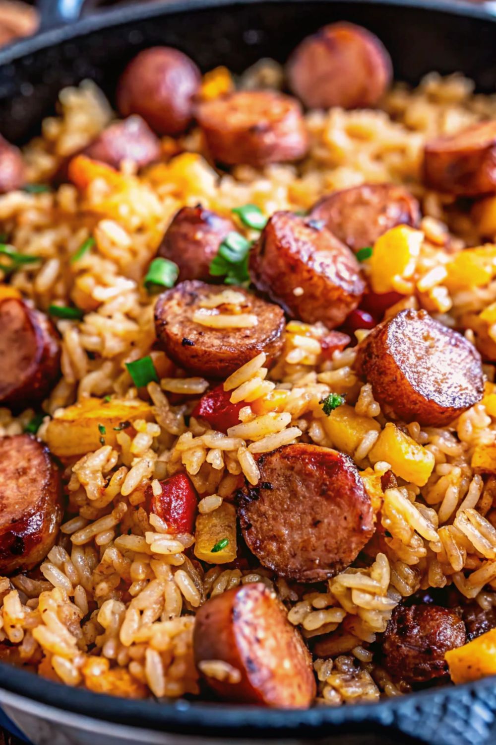 Cajun sausage and rice in a frying pan.