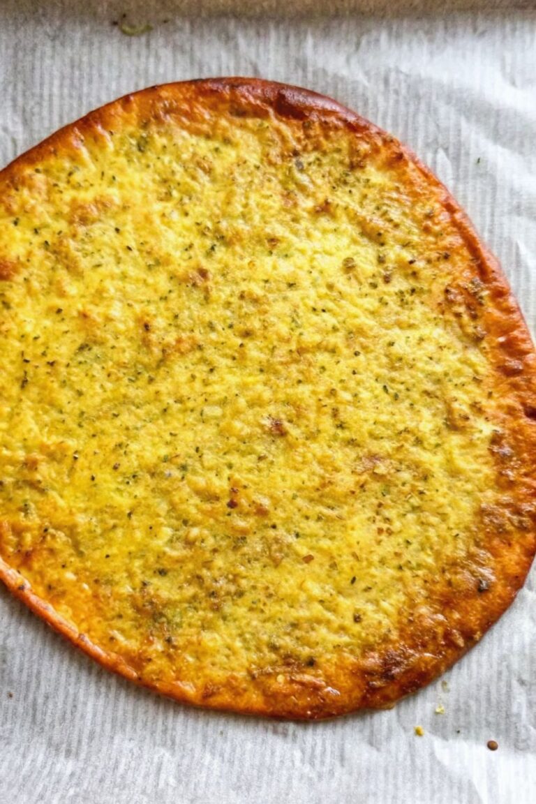 Baked cottage cheese flatbread on baking paper.